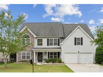 Charming two-story home featuring a stone facade, gray siding, and a well-manicured lawn at 2028 Covered Bridge Ct, Rock Hill, SC 29732