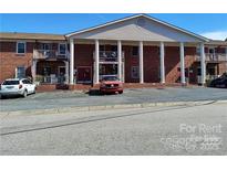 Apartment building featuring a stately facade with brick and prominent columns, complemented by a spacious parking area at 2106 S Main St, Kannapolis, NC 28081