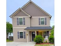 Charming two-story home featuring neutral siding, gray shutters and a cozy front porch at 212 Old Centergrove Rd, Kannapolis, NC 28083