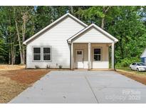 Charming single-story home with white siding and a cozy front porch at 217 E Division Ave, Salisbury, NC 28144