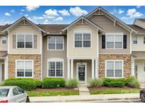 Charming townhome exterior with stone accents, well-maintained landscaping, and a welcoming front porch at 228 Dawn Mist Ln, Fort Mill, SC 29708