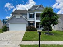 Charming two-story home featuring a two-car garage, well-maintained lawn, and an inviting front porch at 2311 Verde Creek Rd, Charlotte, NC 28214