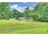 Charming ranch-style home nestled among mature trees with detached garage on a spacious lot at 3017 Brooks Mill Ln # 10, Wingate, NC 28174