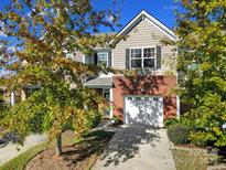 Charming two-story home with brick and siding, complemented by a one-car garage and well-maintained landscaping at 3342 Yarmouth Ln, Gastonia, NC 28056