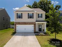 Charming two-story home boasts a brick-accented front and a well-manicured lawn, creating inviting curb appeal at 461 Misty Law Ln, Clover, SC 29710