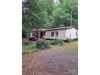 Charming single-story home with mature trees and landscaping around the perimeter at 5023 Dogwood Ln, Stanley, NC 28164