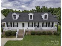 Charming home with a welcoming front porch, dormer windows, and manicured lawn at 532 Jedburgh Way, Rock Hill, SC 29730
