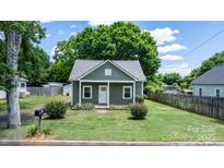 Charming green cottage with a well-maintained lawn and inviting front porch at 639 S Eastway Dr, Troutman, NC 28166