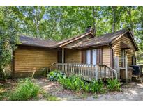Rustic exterior of a cozy home with wooden siding and a quaint front porch at 8007 Red Lantern Rd, Indian Trail, NC 28079