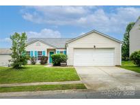 Charming single-story home with attached garage, vibrant turquoise shutters, and well-maintained lawn at 9623 Duxford Ln, Charlotte, NC 28269