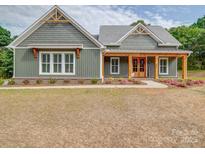 Charming home boasts attractive wood details, manicured landscaping, and a welcoming entrance at 0000 Trull Hinson Rd # 2, Wingate, NC 28174