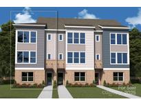 Attractive townhome with a mix of brick and siding, complemented by large windows and well-manicured landscaping at 1104 Bismuth Ln, Charlotte, NC 28211