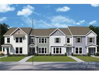 Charming townhome with a welcoming facade, showcasing various color schemes and architectural details against a bright blue sky at 11457 Prosperity Church Rd, Huntersville, NC 28078