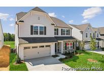 Charming two-story home with a two car garage, stone accents, and a well-manicured lawn at 125 Tangle River Dr # 51, Statesville, NC 28677