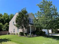Charming two-story home with a well-manicured lawn and mature landscaping at 14413 Lake Crossing Dr, Charlotte, NC 28278