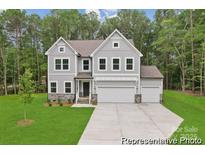Charming two-story home with a manicured lawn, attached two-car garage, and neutral gray siding at 148 Tangle River Dr # 67, Statesville, NC 28677