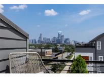 Enjoy stunning city skyline views from this modern home's terrace with seating and skyline at 2108 Bryant Park Dr, Charlotte, NC 28208