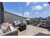Relaxing rooftop deck featuring comfortable seating and stunning city views at 2108 Bryant Park Dr, Charlotte, NC 28208