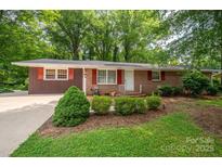 Charming brick home featuring a well-manicured front yard, tasteful landscaping, and a welcoming entrance at 3120 7Th Street Ne Dr, Hickory, NC 28601