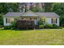 Charming single-story home with a well-maintained lawn and a quaint front porch entry at 321 Woodcrest Dr, York, SC 29745