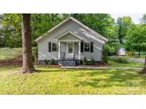Charming gray home with a gabled roof, dark shutters, and a well-manicured lawn at 352 18Th Ne Ave, Hickory, NC 28601