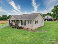 Charming single-story home with a welcoming front porch and well-maintained lawn at 4115 Jenkins Rd, Marshville, NC 28103