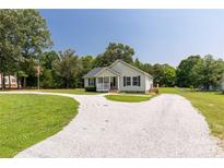 Charming single-story home with an expansive driveway, well-maintained lawn, and a welcoming front porch at 4285 Palmer Lloyd Rd, Lancaster, SC 29720