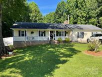 Charming single-story home with a welcoming front porch and a well-manicured lawn at 4337 Gelinda Ct, Gastonia, NC 28056
