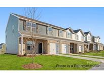 Street view of townhomes with brick facade, attached garages, and well-maintained lawns at 502 Mt. Mitchell Ave # 502, Gastonia, NC 28052