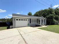 Charming single-story home with attached garage, manicured lawn, and inviting curb appeal at 5323 Flat Creek Rd, Heath Springs, SC 29058