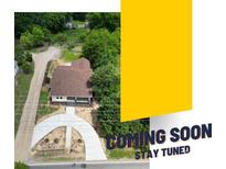 An aerial view of a home with a circular driveway and a lush, green yard at 933 Old Charlotte Rd, Concord, NC 28027