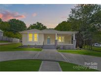 Charming single-story home featuring manicured lawn, covered porch, and inviting curb appeal at 933 Old Charlotte Rd, Concord, NC 28027