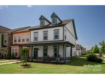 Charming two-story home featuring a welcoming front porch and well-manicured lawn at 1036 Riverwalk Pkwy, Rock Hill, SC 29730