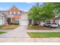 Charming townhouse with a well-manicured lawn, a driveway, and a one car garage at 11714 Harsworth Ln, Charlotte, NC 28277