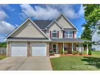 Charming two-story home featuring stone accents, a two-car garage, and a welcoming front porch at 166 Glenn Allen Rd, Mooresville, NC 28115
