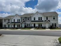 Attractive townhouse complex with a sidewalk and well-manicured yards is ideal for modern living at 205 Cliffwood Nw St # A-1, Concord, NC 28027