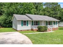 Charming ranch-style home featuring a well-maintained lawn, classic siding, and a welcoming front porch at 2223 Pacer Rd, Lancaster, SC 29720