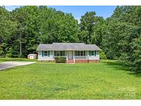 Charming single-story home with well-maintained front yard and a cozy porch at 2223 Pacer Rd, Lancaster, SC 29720