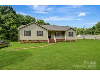 Charming single-story home with a well-manicured lawn and inviting front porch at 3125 Leonard Dr, Gastonia, NC 28056
