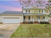Charming two-story home featuring a covered front porch and attached two-car garage at 3572 Heather Ln, Gastonia, NC 28056