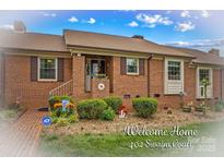 Charming brick home featuring well-maintained landscaping, a welcoming front entrance, and lovely curb appeal at 402 Swaim Ct, Salisbury, NC 28147