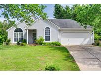 Charming single-story home with well-manicured lawn and attached garage on a sunny day at 4712 Avalon Forest Ln, Charlotte, NC 28269