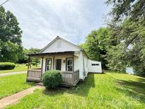 Charming single-story home with a covered porch and a well-maintained front yard at 502 E Main St, Cleveland, NC 27013