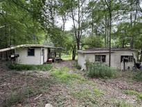 Rustic home exterior with two small cabins nestled within a wooded area at 509 Waring Ct, Fort Mill, SC 29707