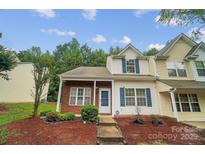Charming townhouse with brick accents, blue shutters, and a well-maintained front yard landscape at 5237 Ficus Tree Ln, Charlotte, NC 28215