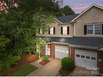 Charming townhome featuring a brick facade, attached garage, and well-manicured front yard at 5305 Waverly Lynn Ln # 4A, Charlotte, NC 28269