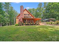 Inviting exterior showcasing a warm-toned home with a covered porch and well-manicured lawn at 6350 Mount Pleasant S Rd, Concord, NC 28025