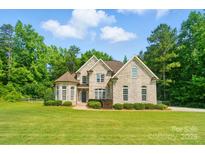 Beautiful two-story home features a brick facade, mature trees, and a well-maintained lawn at 7006 Nesbit Rd, Waxhaw, NC 28173