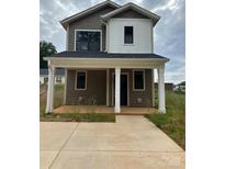 Charming two-story home with a covered front porch and a modern color scheme at 804 3Rd Street Sw Pl, Hickory, NC 28602