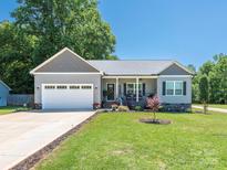 Charming home with well-maintained front yard, inviting entrance, and attached two-car garage at 805 Brookmont Ave, Salisbury, NC 28146